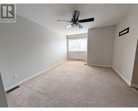 A spacious room with a ceiling fan and a window.