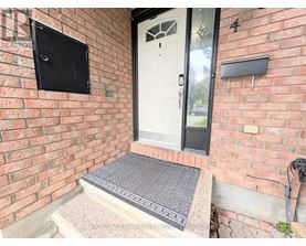 A white door is on the right side of a brick wall.