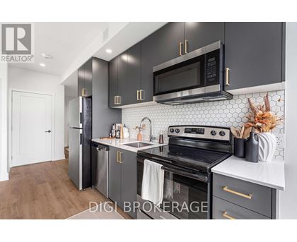 A modern kitchen with a black microwave above the stove.