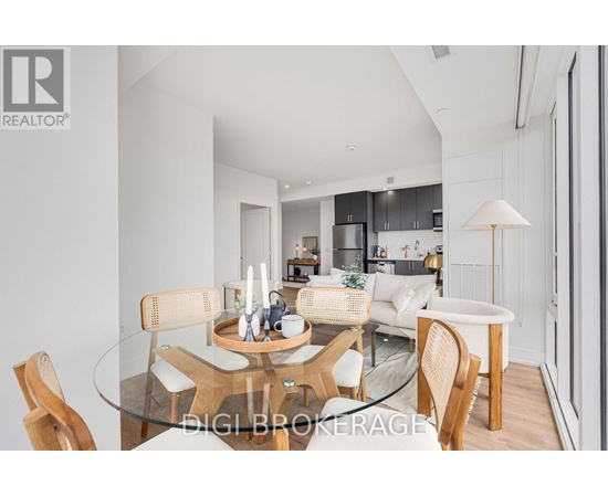 A modern dining room with a glass table and chairs.