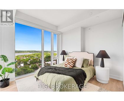 A bedroom with a large bed and a view of the city.
