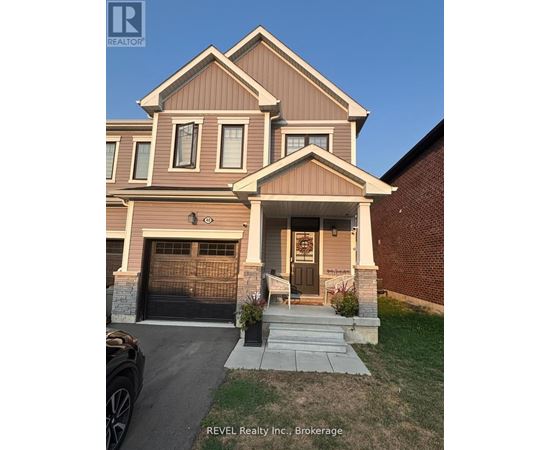 A house with a brown and beige exterior is for sale with REVEL Realty Inc.