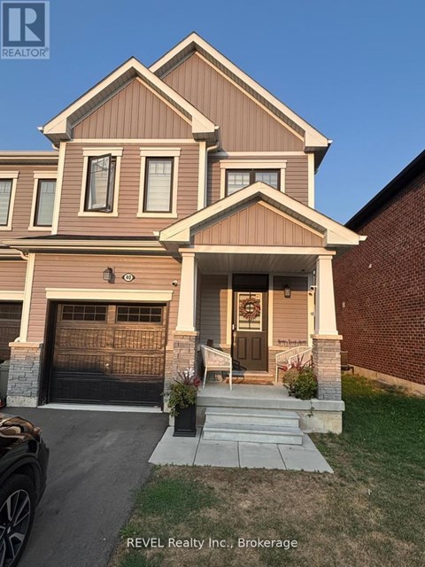 A house with a brown and beige exterior is for sale with REVEL Realty Inc.