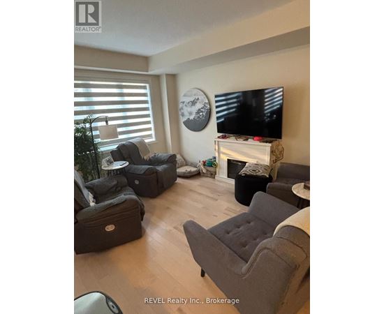 A living room with a grey couch and a television.