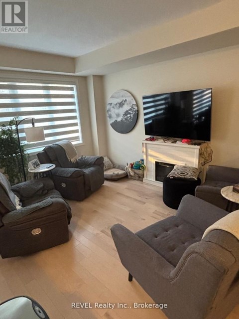 A living room with a grey couch and a television.
