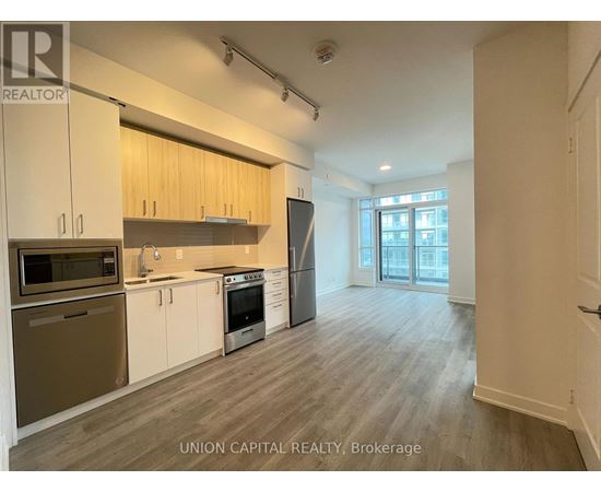 A kitchen with wooden cabinets and stainless steel appliances.