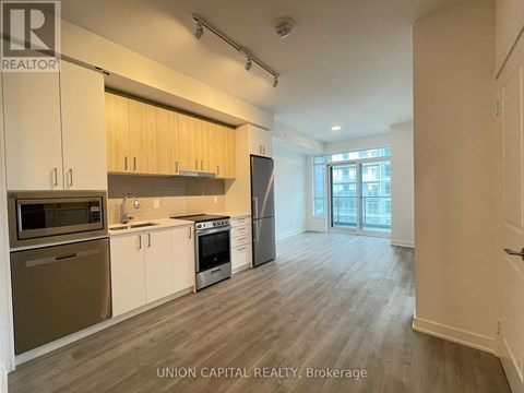 A kitchen with wooden cabinets and stainless steel appliances.