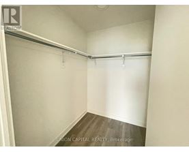 A white bedroom with a bed frame and no bed.