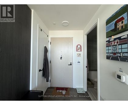 A hallway with a door on the left and a door on the right.