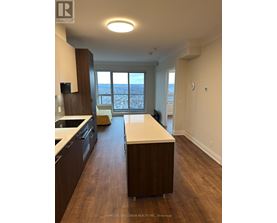 A kitchen with dark wood cabinets and a white countertop.