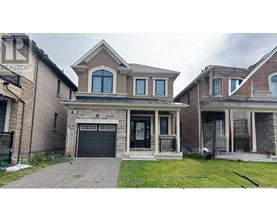 A house with a garage and a driveway in front.