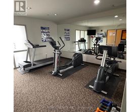 A gym with treadmills, elliptical machines, and other exercise equipment.