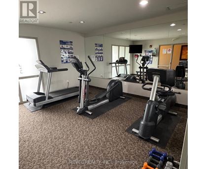 A gym with treadmills, elliptical machines, and other exercise equipment.