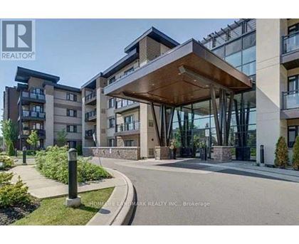 A modern building entrance with a glass wall and a wooden canopy.