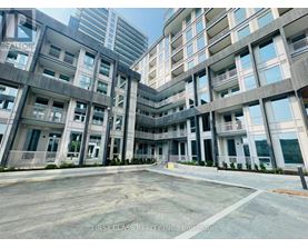A large, modern building with the words "First Class Realty Inc." on the side.