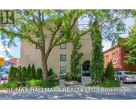 A building with the sign RE/MAX Hallmark Realty LTD, Brokerage in front of it.