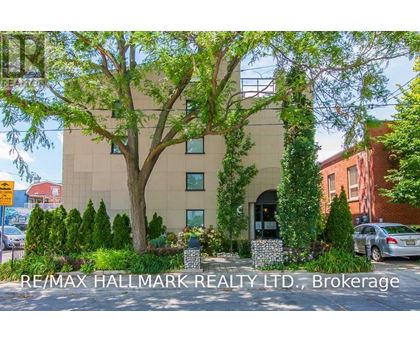 A building with the sign RE/MAX Hallmark Realty LTD, Brokerage in front of it.