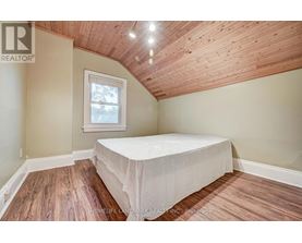 A bedroom with a bed and a window.