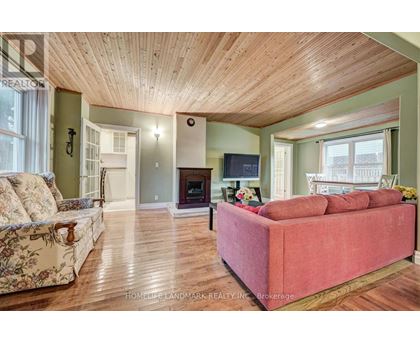 A living room with a red couch and a fireplace.