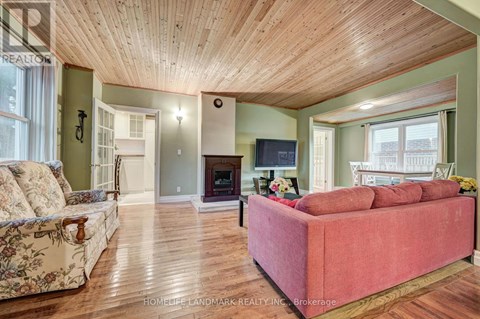 A living room with a red couch and a fireplace.