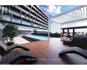 A modern outdoor pool area with a wooden deck and lounge chairs.