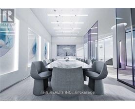 A modern conference room with a large table and chairs.
