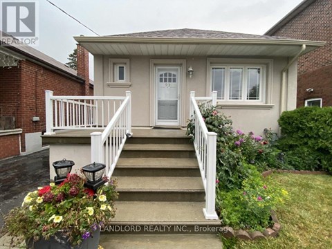 A house with a front porch and stairs leading to the door.