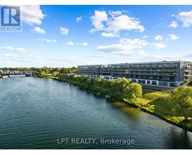 A river flows through a city with a bridge in the background and a building with the sign LPT REALTY, Brokerage.