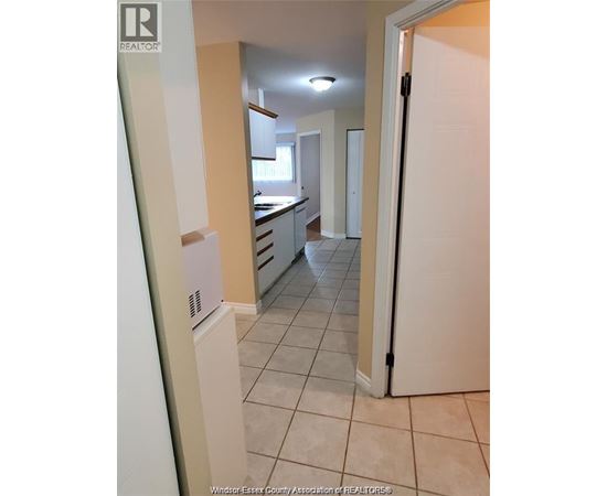 A kitchen with white appliances and a white refrigerator.