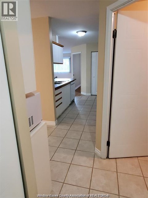 A kitchen with white appliances and a white refrigerator.