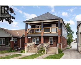 A house with a balcony and a sign that says REALTOR.