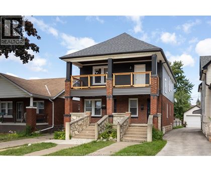 A house with a balcony and a sign that says REALTOR.