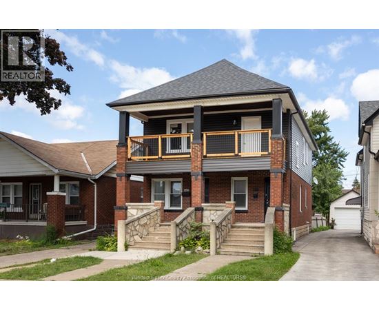 A house with a balcony and a sign that says REALTOR.