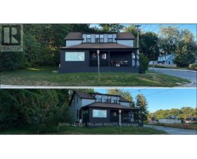 A house with a sign that says REALTOR in the upper left corner.