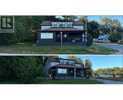 A house with a sign that says REALTOR in the upper left corner.