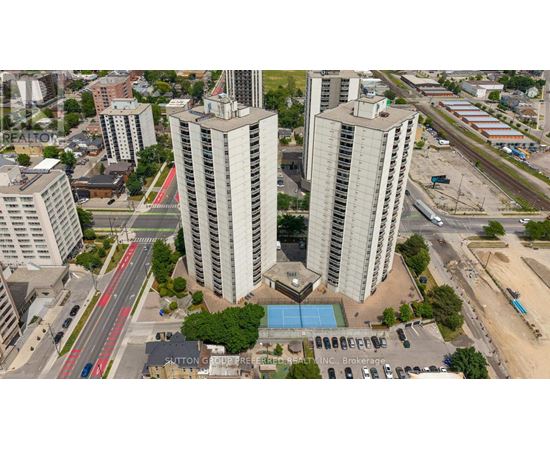 A view of a city with tall buildings, a pool, and a parking lot.