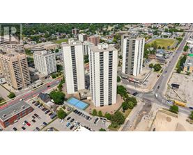 A cityscape with tall buildings and a busy intersection.