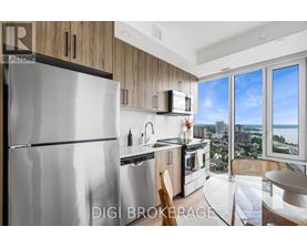 A modern kitchen with a stainless steel refrigerator and wooden cabinets.
