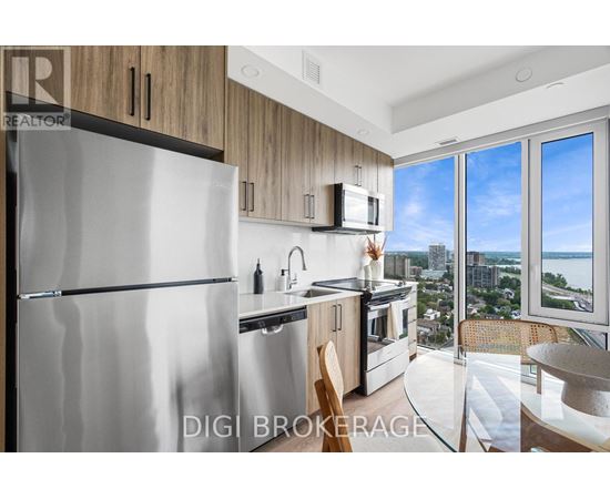A modern kitchen with a stainless steel refrigerator and wooden cabinets.