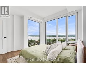 A bedroom with a large bed and a view of the water.