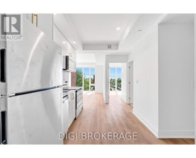 A modern kitchen with a refrigerator and a view of the outdoors.