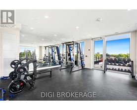 A well-equipped gym with a view of the cityscape outside.