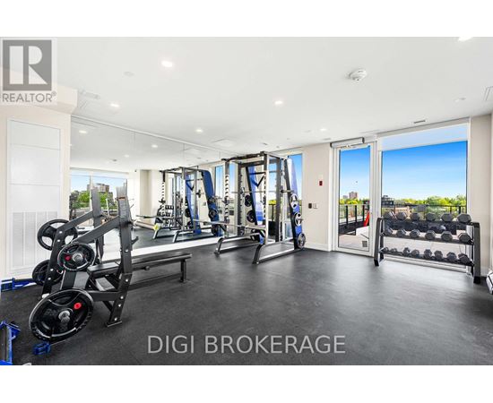 A well-equipped gym with a view of the cityscape outside.