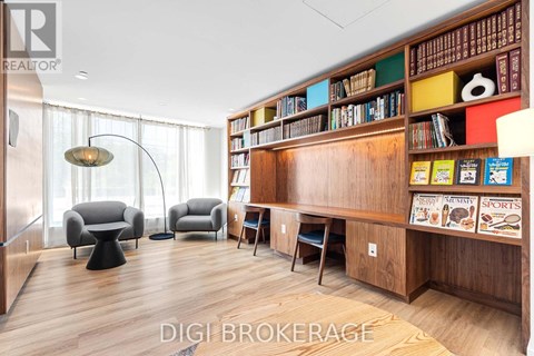 A living room with a bookshelf filled with books and magazines.