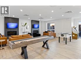 A room with a pool table and a television.