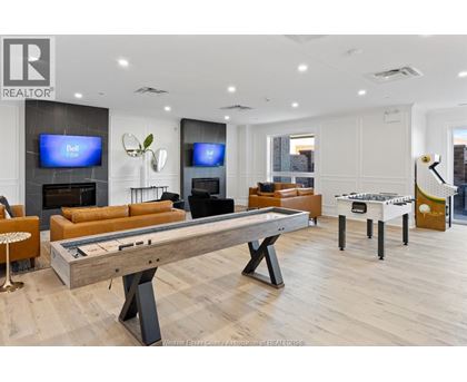 A room with a pool table and a television.