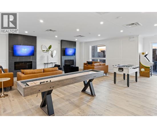 A room with a pool table and a television.