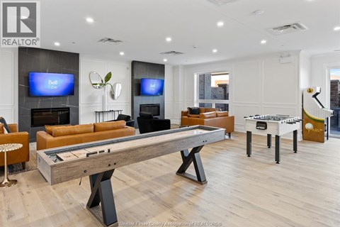 A room with a pool table and a television.