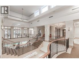 A large, well-lit, and spacious interior of a building with a curved staircase.