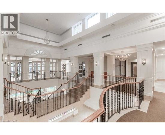 A large, well-lit, and spacious interior of a building with a curved staircase.